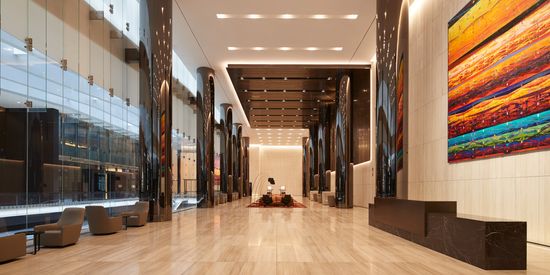 A wide, spacious lobby of a tower at Collins Square