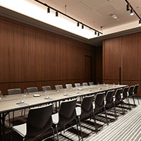 Large long table set up at the breakout space at Collins Square