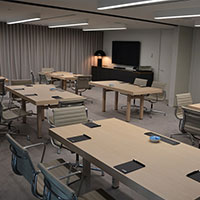 Multiple desks and chairs set up spaced out withing the multi-purpose meeting room at Collins Square