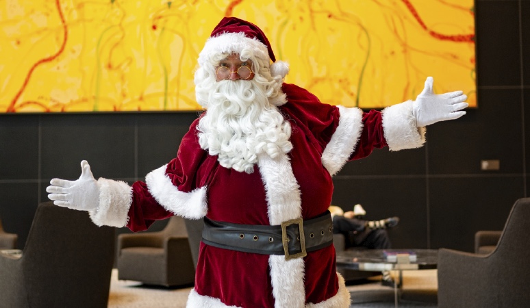 Corporate Santa Clause posing for a photo in one of the lobbies at Colling Square.