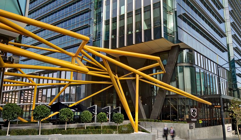 The entrance to a tower of Collins Square showcasing the large artpiece.