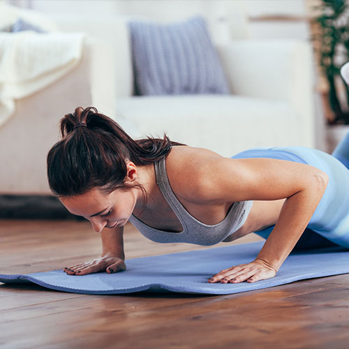 A woman exercising on a mat