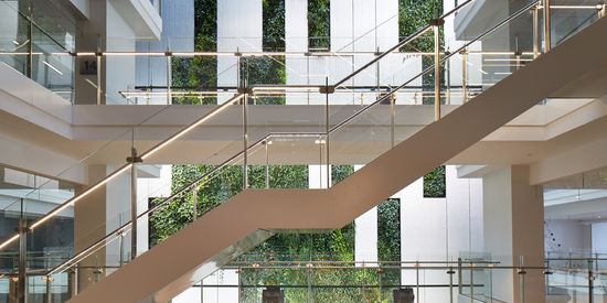 A close up of the glass facade of one of the towers at Collins Square