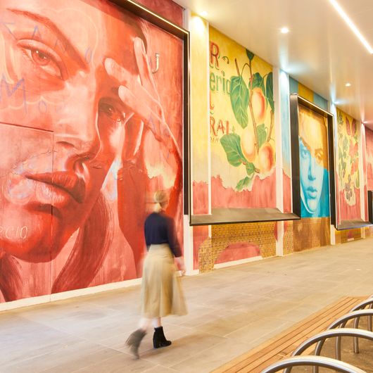 A striking feature wall of various paintings within Tower 5 at Collins Square