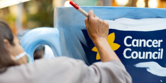 Artist painting a Daffodil for a Cancer Council Daffodil Day Appeal at Collins Square